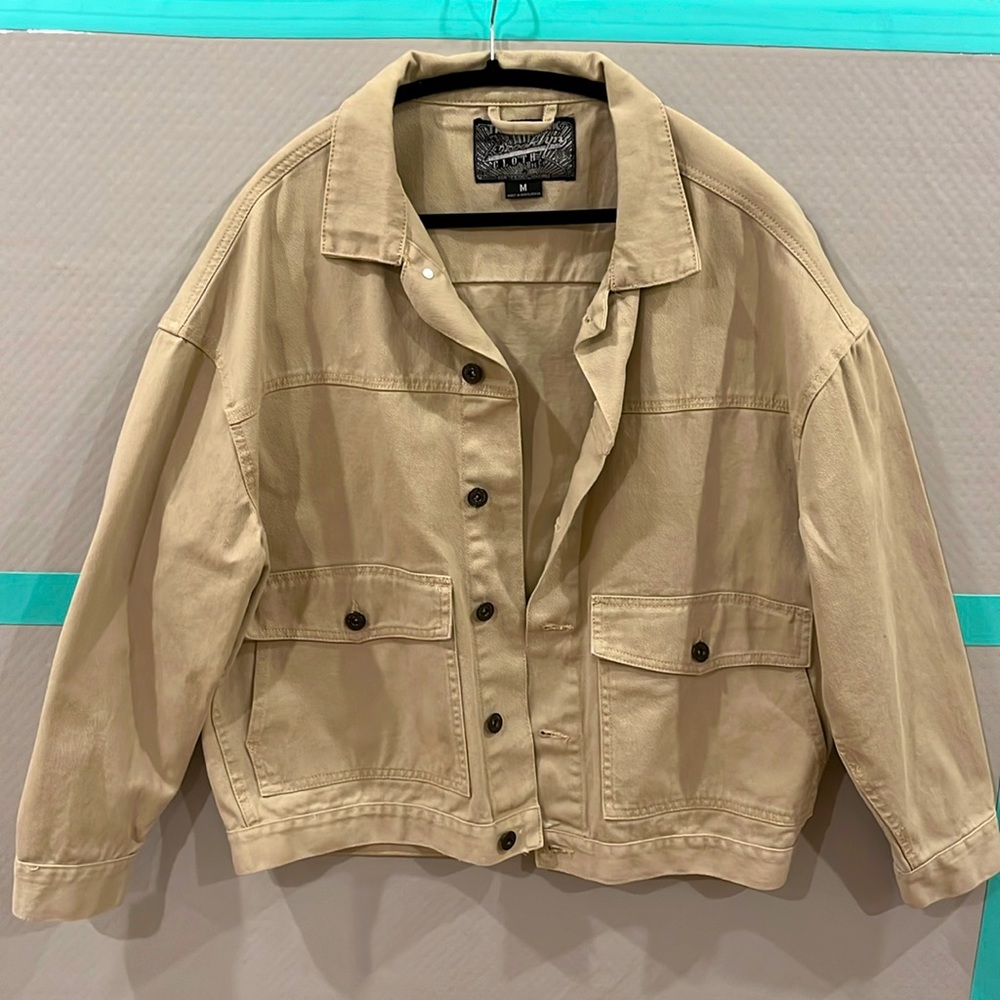 It’s a beige oversized  coat